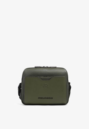 Compact olive green leather crossbody bag with front pocket, zipper closure, and adjustable shoulder strap.