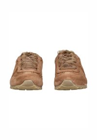 Brown suede athletic shoes with a textured surface, featuring a rounded toe, rubber soles, and sheer laces with pink accents.