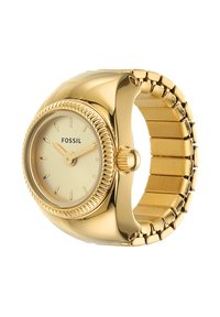 Montre Fossil dorée avec un cadran rond, une lunette striée et un bracelet en métal lisse. Le cadran est de couleur or pâle avec des index et des aiguilles simples.