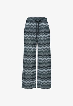 Wijde broek met zwart- en grijs zigzagpatroon en zwarte tailleband met trekkoord, van voren weergegeven op witte achtergrond.