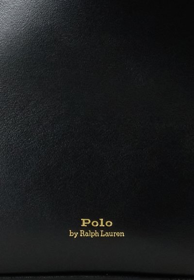 Melnās ādas maks ar gludu tekstūru un zelta logotipu ar uzrakstu "Polo by Ralph Lauren" apakšā. Minimālistisks dizains, bez papildu rotājumiem.
