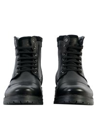 Bottes en cuir noir à la cheville avec lacets et zips sur le côté, bout arrondi, semelles en caoutchouc et coutures décoratives sur le dessus.