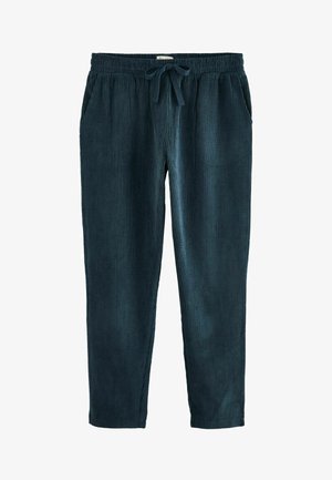 Pantaloni in velluto a coste verde scuro con cintura elasticizzata e cordino, dotati di due tasche laterali e una texture a coste.