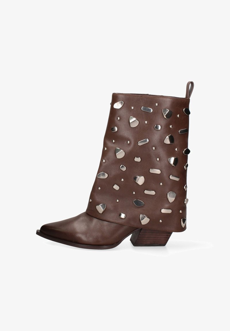 Bruine leren enkellaars met lage houten hak, spitse neus, trekflap en verspreide zilveren studs in verschillende vormen.