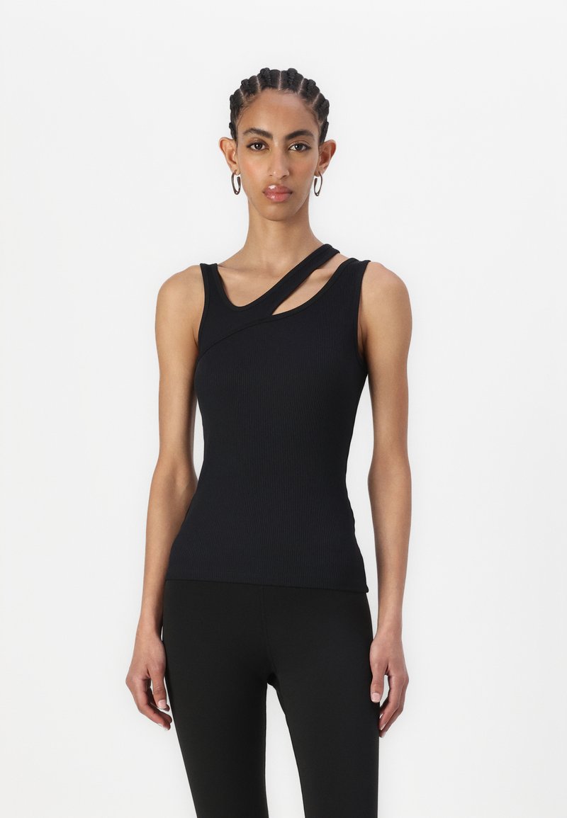 Svart ribbet tank topp med en unik asymmetrisk halslinje og en skulderstropp. Designet med en tettsittende silhuett og stretchstoff.
