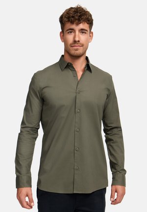 Knappskjorte i olivengrønn, slim fit, laget av glatt stoff. Har krage og lange ermer med knappede mansjetter.