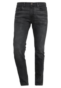 Svarta denimjeans med slim fit, femficksdesign, subtila sömmar och knappförslutning. Slät textur med lätt urtvättning.