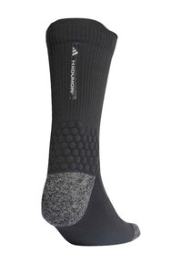 Calcetín negro hasta la rodilla con textura acanalada, agarre hexagonal de goma en el tobillo y sección del talón y la punta en gris jaspeado. Presenta etiqueta con logo.