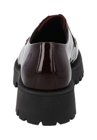 Burgundy patent leather shoe with a thick black rubber sole, featuring a rounded toe and minimal stitching detail on the upper.