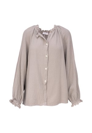 Blouse beige clair à manches longues avec boutonnage sur le devant, tissu texturé, col et poignets à volants avec détails en dentelle.