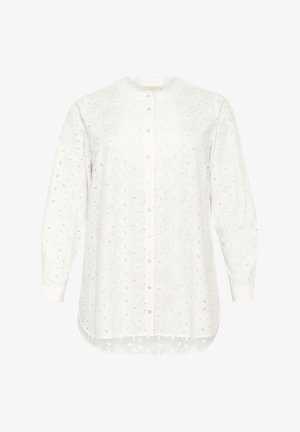 Blouse blanche à manches longues avec des motifs floraux découpés complexes, fermeture à boutons à l'avant et col rond. Tissu doux et respirant.