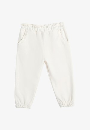 Pantalones de forro polar blancos con cintura elástica y borde con volantes. Cuenta con dos bolsillos laterales y puños elásticos en el tobillo. Textura suave.