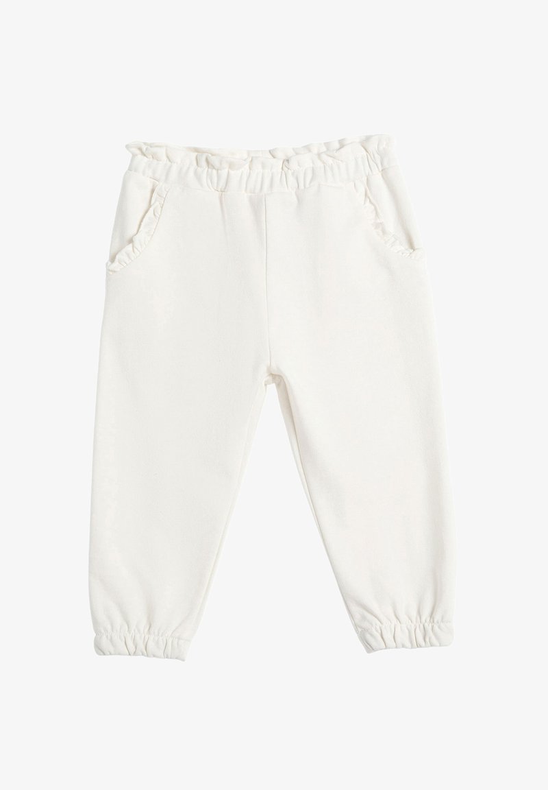 Pantalones de forro polar blancos con cintura elástica y borde con volantes. Cuenta con dos bolsillos laterales y puños elásticos en el tobillo. Textura suave.
