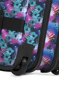 Hard-shell suitcase featuring a colorful floral design on a black background, with black wheels and a textured surface for grip.