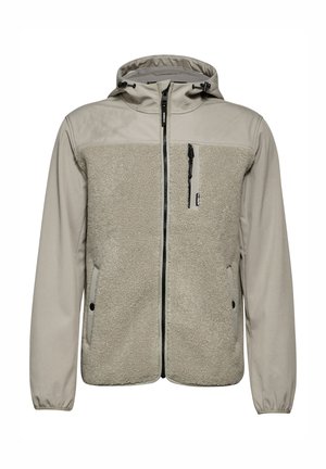 Beige takki, jossa on pehmeä fleece-etuosa ja sileät hihnat. Varustettu vetoketjulla edessä, säädettävällä hupulla ja vetoketjullisella rintataskulla.