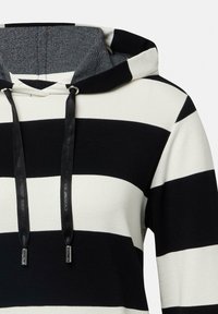Pasiasta bluza z kapturem w czerni i kremie, z teksturowanym wykończeniem kaptura, sznurkami z metalowymi akcentami oraz luźnym krojem.