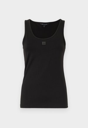 Black tank top made of smooth, stretchy fabric. Features a round neckline and a small logo patch on the front. Simple, fitted design.