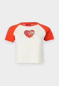 Short-sleeve, cropped T-shirt with red raglan sleeves. Features a colorful graphic of a deer with a bow on a white background.