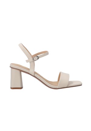 Beige leather sandal with a block heel, open toe, and two straps. The ankle strap features an adjustable buckle for secure fit.