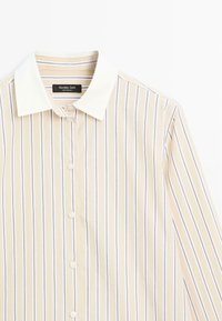 Button-up shirt with a white collar, featuring thin vertical stripes in cream and lavender colors. Made from a smooth fabric.