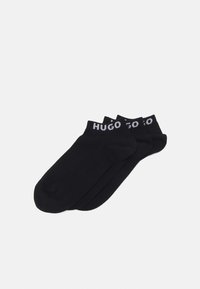 Schwarze Knöchelsocken mit einer weichen Textur und einem elastischen Bund mit dem weißen "HUGO"-Logo. Drei Paare mit einem schlichten, einheitlichen Design.