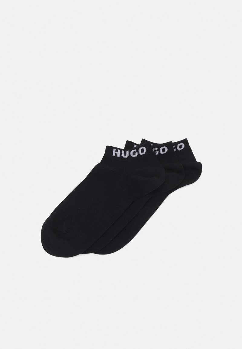 Schwarze Knöchelsocken mit einer weichen Textur und einem elastischen Bund mit dem weißen "HUGO"-Logo. Drei Paare mit einem schlichten, einheitlichen Design.