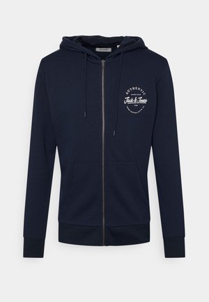Navy zip-up hoodie made from cotton, featuring a front pocket, drawstring hood, and a white graphic logo on the chest.