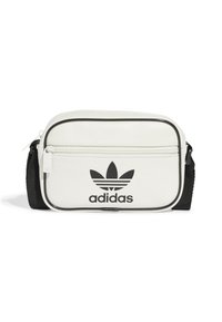 Borsa a tracolla sintetica bianca con zip nera, tracolla nera e logo Adidas nero in evidenza sulla parte anteriore. Forma piccola e rettangolare.