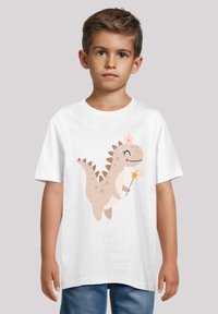 White cotton t-shirt featuring a cartoon dinosaur in beige with a crown and magic wand, set against a neutral background.