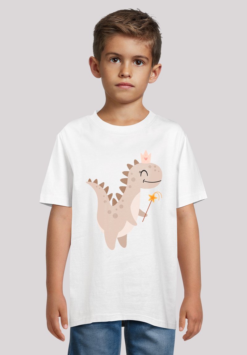 White cotton t-shirt featuring a cartoon dinosaur in beige with a crown and magic wand, set against a neutral background.