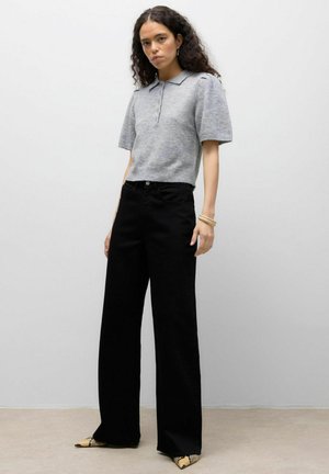 Gray short-sleeve polo shirt paired with high-waisted black wide-leg pants. Shoes feature a pointed toe with a snake print detail.
