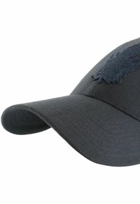 Dark blue baseball cap with a curved visor, featuring an embroidered leaf design on the front, made of cotton blend fabric.