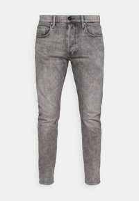 Grå denim jeans med slim fit, med frontlommer, en metallknap-lukning og subtil falming over hele stoffet.
