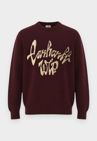 Pull bordeaux à manches longues avec poignets côtelés et motif de texte duveteux couleur crème à l'avant.