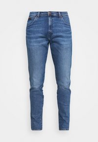Blå denimjeans med en slim fit-design, som har knappstängning, fem fickor och subtila blekningar. Slät yta med klassisk sömnad.
