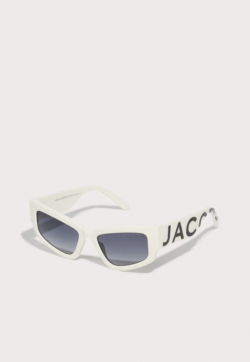 White rectangular sunglasses with dark gradient lenses, featuring a bold black logo on the arms. Smooth plastic frame with angular design.