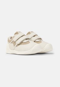 Weiße und beige Klettschuhe mit einer strukturierten Oberseite, gepolsterten Kragen und einer Gummisohle, die ein sportliches Design und minimalistische Akzente aufweisen.