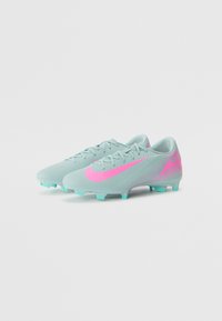 Light blue soccer cleats with pink accents and a textured surface, featuring a pointed toe, laces, and multiple traction studs on the sole.