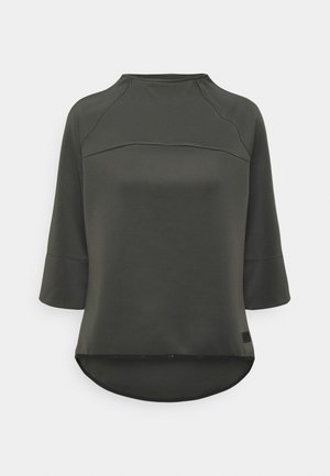 Mörkgrön långärmad topp med rund hals, som erbjuder en avslappnad passform, med en böjd nederkant och diskreta sömnadsdetaljer.