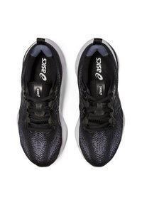 Sneaker sportive nere con una toma superiore texturizzata, caratterizzate da una suola liscia, lacci e logo. Il design include linee eleganti e una silhouette moderna.