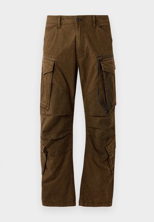 Pantaloni cargo in cotone marrone, con molte tasche grandi, dettagli cuciti e una vestibilità rilassata con una cerniera sulla gamba.