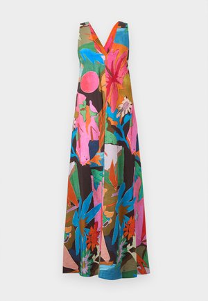 Woman wearing sleeveless, multicolored, abstract floral maxi dress with brown flat sandals, standing against a plain background.