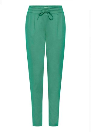 Zelené joggingové kalhoty vyrobené z měkké tkaniny, s elastickým pasem, stahovací šňůrkou a dvěma bočními kapsami s designem slim fit.