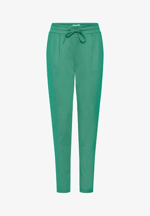 Pantalons de jogging verts en tissu doux, avec une taille élastique, un cordon de serrage et deux poches latérales, au design ajusté.