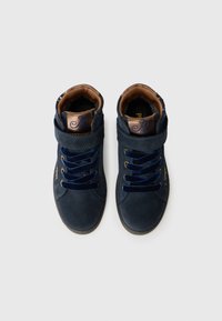Navy blue suede high-top sneakers with brown accents, featuring laces, inner cushioning, and a logo on the tongue.
