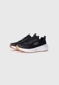 Black athletic shoes with a mesh upper, white midsole, and light brown rubber outsole. Features laces, looped heel tab, and logo detail.
