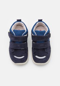 Navy blue sneakers with Velcro straps, suede upper, mesh tongue, white accents, and rubber sole. Designed for comfort and ease of wear.