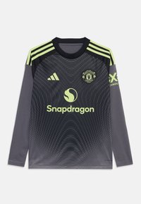 Maillot de football à longues manches gris avec des accents vert lime, présentant un motif texturé, un col rond et des logos de Manchester United et de Snapdragon.