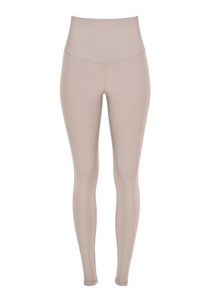 Beige high-waisted women’s leggings with seamless front and fitted full-length legs on a white background.
