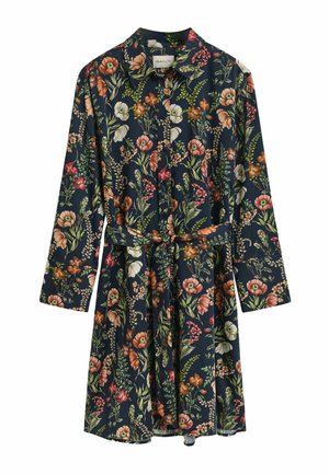 Bloemig shirtjurk met lange mouwen, gemaakt van lichtgewicht stof. Heeft een marineblauwe achtergrond met meerkleurige bloemen en een tailleband.